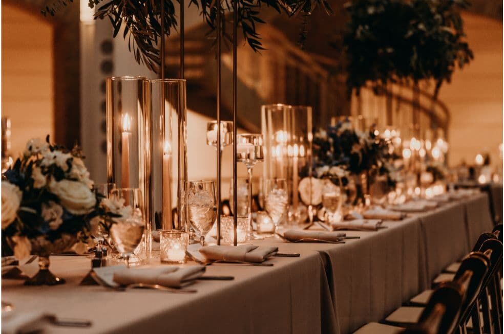 elegancki stół ślubny z dekoracją ze świec i białych kwiatów